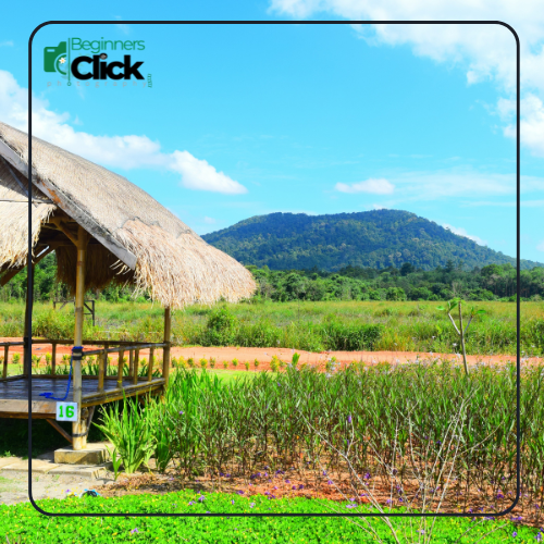 Wide-angle landscape photograph showing a hut, green fields, and distant mountains, with everything in sharp focus, illustrating the effect of focusing distance on depth of field.