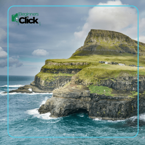 A scenic landscape with cliffs and the ocean, captured in sharp focus from the foreground to the distant mountains, showcasing a deep depth of field.