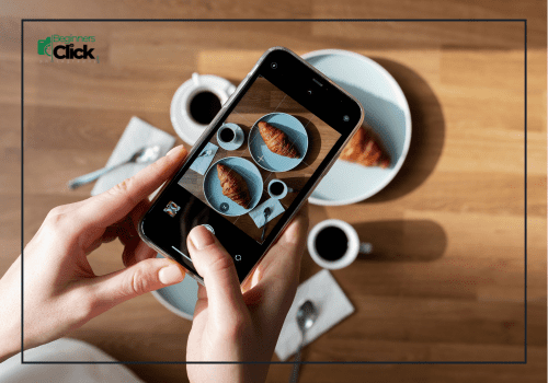 Clean That Lens (Seriously) Hands holding a smartphone to take a flat lay food photo of a croissant and coffee cups.