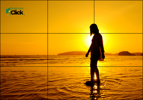 Golden Hour Walk by the Sea A silhouette of a woman walking in shallow water during a golden sunset at the beach, captured using the rule of thirds.