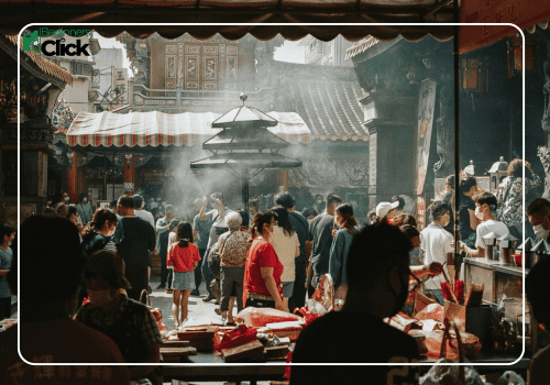 Atmosphere & Ritual – Travel Photography A busy temple interior with people engaged in rituals and daily activity, light filtering through smoke and architecture, labeled with the Beginners Click Photography logo.