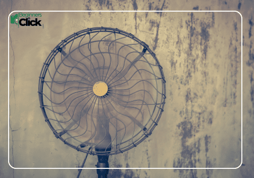 Understanding Motion Blur – Shutter Speed in Practice A vintage-style standing fan captured in front of a textured, weathered wall under soft lighting.