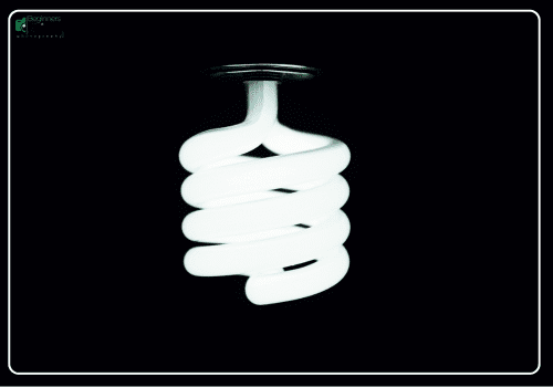 Spiral CFL Bulb – Minimalist Lighting Photography Close-up of a glowing spiral CFL bulb against a black background.